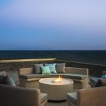 lounge area with fire pit by the pool