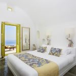Maste bedroom with yellow elements and pool view