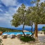Pool deck with a big tree and view to the Ionian Sea