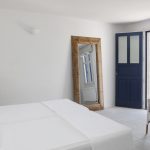 double bedroom with mirrors and blue door