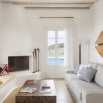 living area with traditional fireplace and window