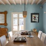 Dining area surrounded by baby blue walls