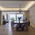 Wooden dining table indoors with access to the pool deck