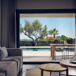 Indoors lounge area open to the pool deck