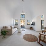 Spacious living room with white walls in the luxury villa Capo