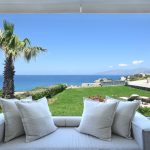 lounge space in the garden next to the palm trees