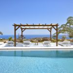 Pool, shaded lounge area and endless view of Kalafatis beach