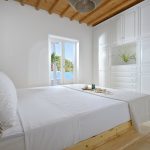 Bedroom with double bed and window with sea view