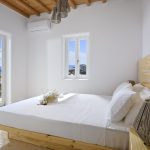 Bedroom with double bed and window with sea view