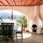 Outdoor dining area with wooden oven and BBQ