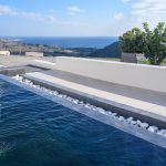 Blue waters in the pool of villa capo in Santorini