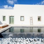 White stones, pool and white facades in the villa