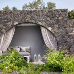 Outdoor lounge space with stone walls