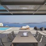 Outdoor dining with pool and sea view