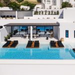 Sun loungers at the pool deck of villa in Psarou