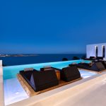 Night view of Psarou bay from the pool deck