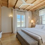 Bedroom with fan and wooden roof