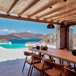 Shaded dining area with pool and sea view