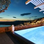 Night view of the pool in Myconian Villa