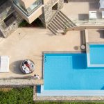 Sunbathing by the pool gazing at the superb views of the Aegean Sea