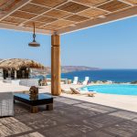 Pool bar and shaded pergola with sea view in Myconian Estate
